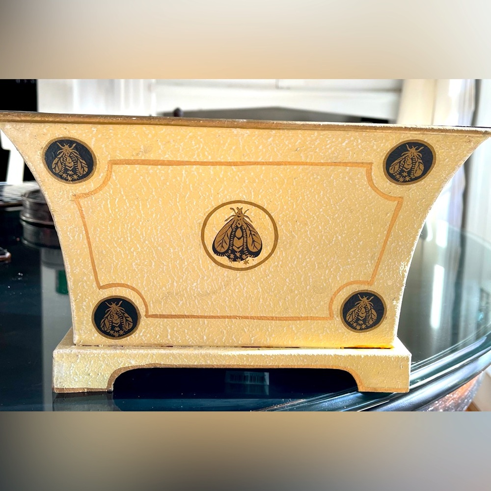 Tole planter with bee and gold accents.